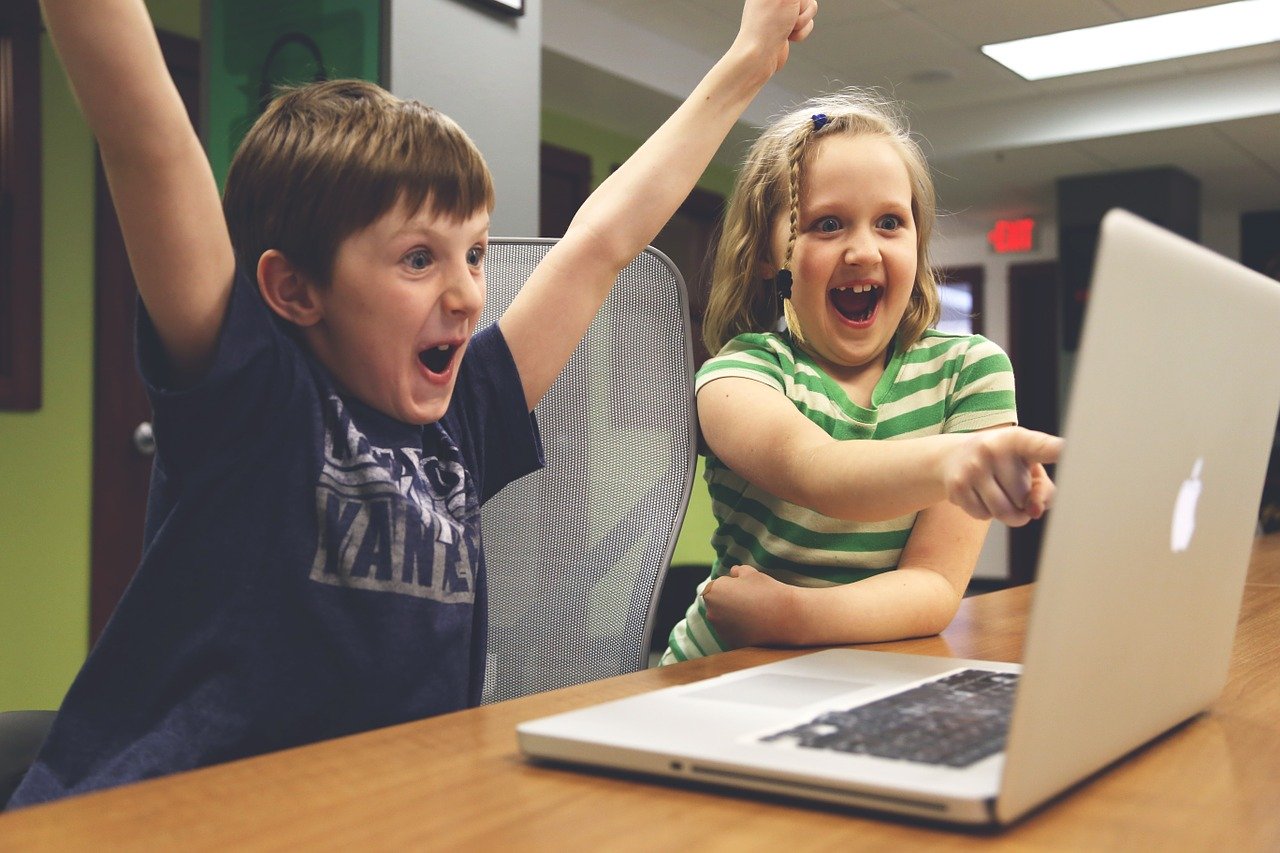 Children happy in front of computer